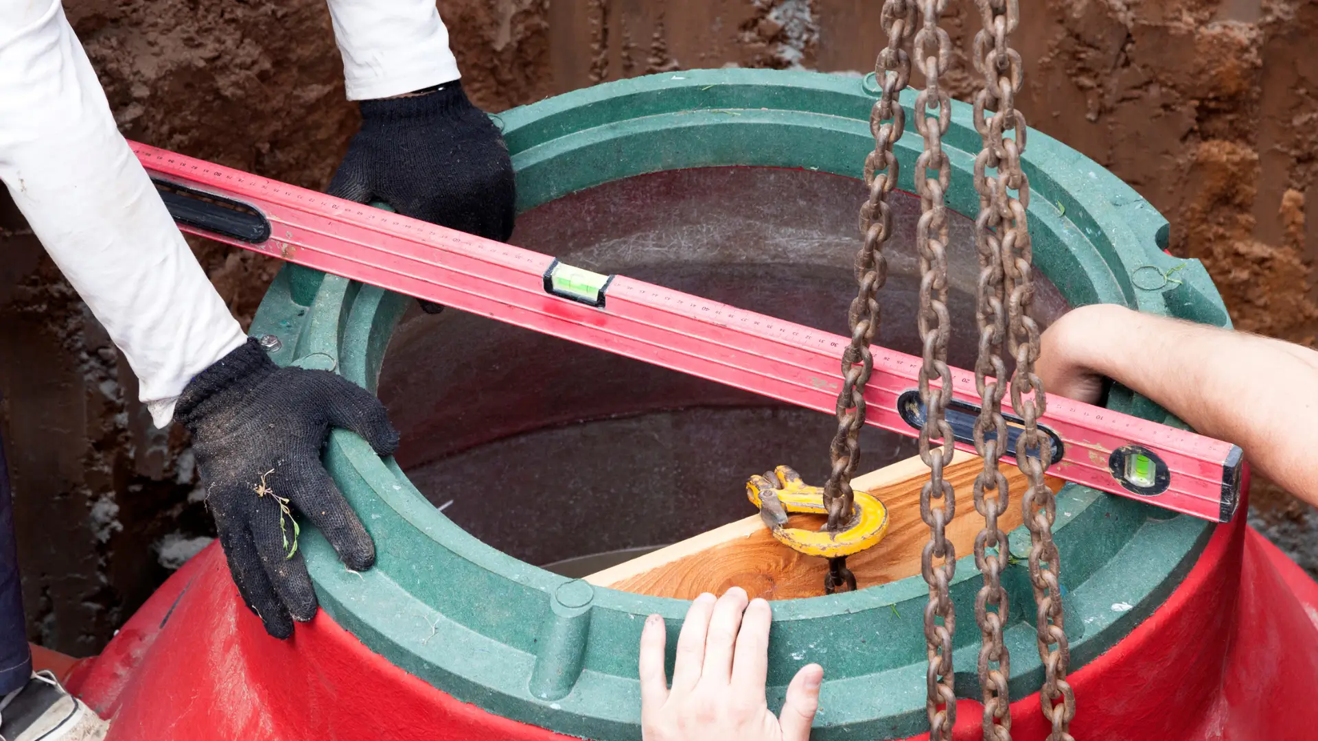Best water tank installation company East Auckland for any job image showing technicians placing a tank access riser during Water Tank Installation East Auckland work.